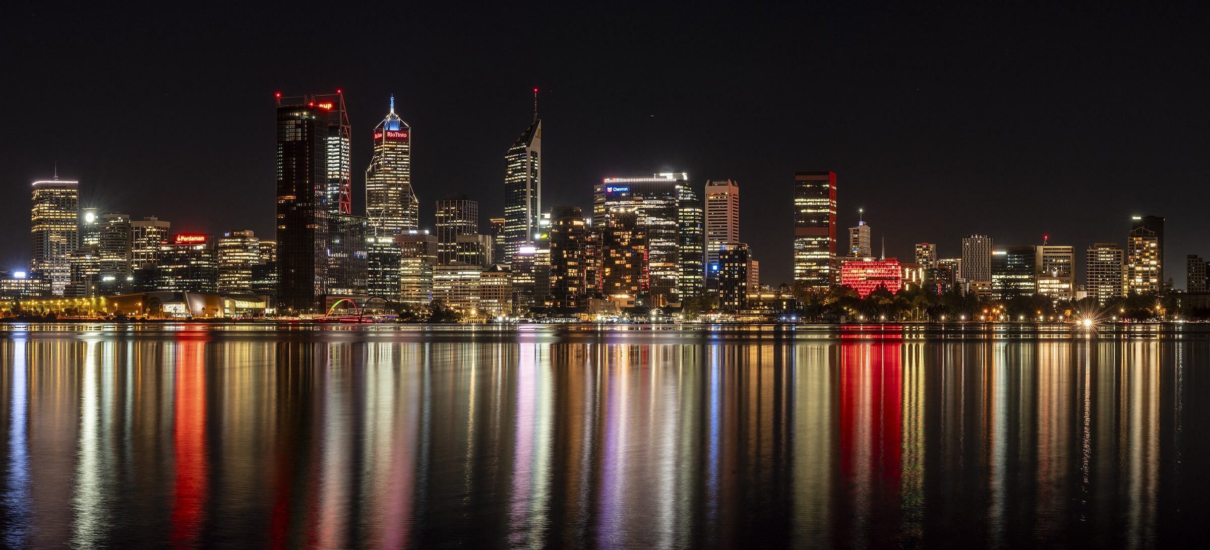 Perth CBD skyline lit up at night over the Swan River